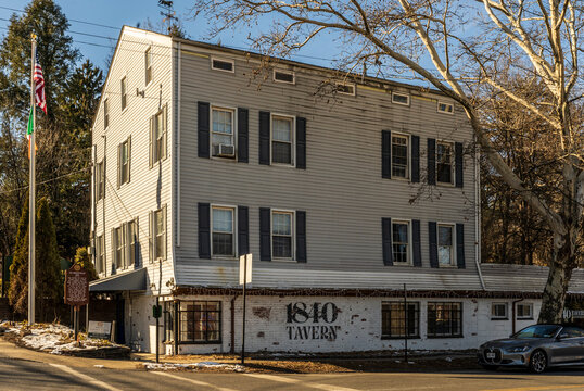 West Nyack, NY - US - Jan 24, 2026 Historic 1840 Tavern, formally the Clarksville Inn a roadside inn with winter light, bare trees, American flag, and small-town Hudson Valley charm.