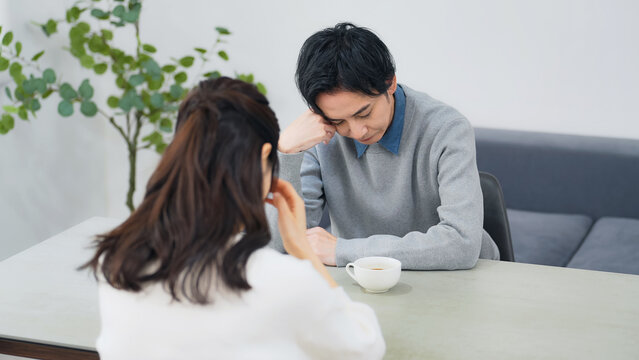 部屋で落ち込む男女カップル