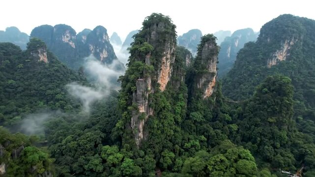 Dynamic aerial drone footage showcases majestic zhangjiajie national forest park mountains and lush forest, creating a breathtaking natural landscape