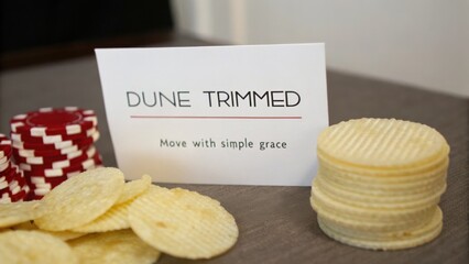 Elegant Dune Trimmed Table Setting with Casino Chips and Gourmet Wafers for a Classy Game Night Atmosphere