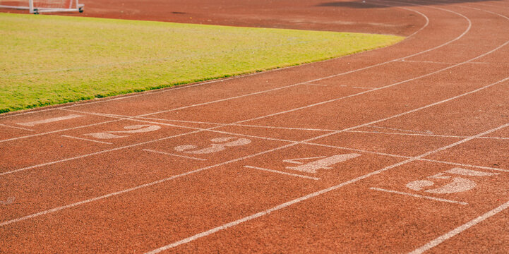 A vibrant running track marked with lanes and starting points promises speed and competition
