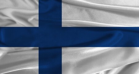 Naklejka premium Flag of Finland with fabric textured background. Close up of National flag of Finland with realistic texture