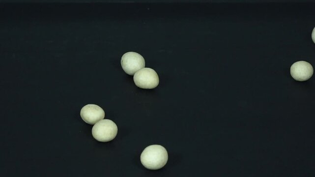 Rolling Object on Black Background (Peanut Flour Concept)