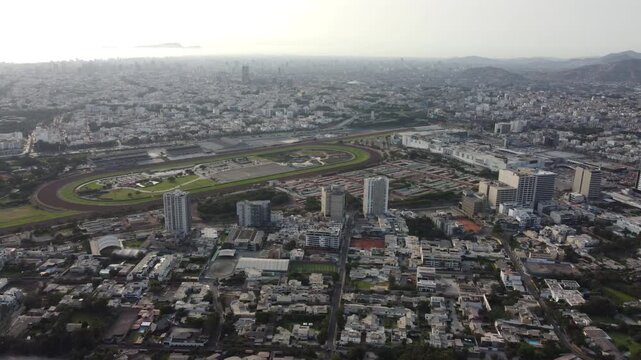 aerial view lima city monterrico track drone footage showing expansive urban sprawl and green oval