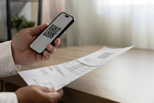 Scan payment confirmation concept with QR code on smartphone and paper receipt, representing cashless checkout, digital billing, invoice verification and secure mobile finance successful payment