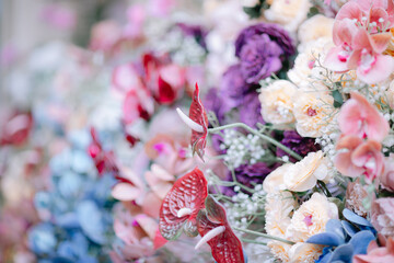 Beautiful floral arrangement with red anthurium and pastel roses for wedding background concept