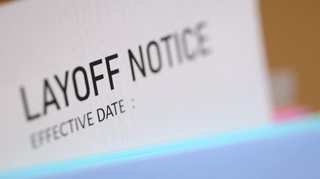 Close up view of a layoff notice paper, symbolizing job loss, unemployment, and economic recession