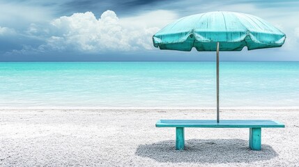 Turquoise beach umbrella and bench on a white pebble beach.