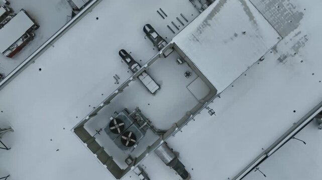 Snowy HVAC units ontop of a office building seen from a drone in Raleigh, North Carolina