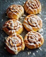 Golden brown cinnamon swirls with sweet white icing rolls pastry