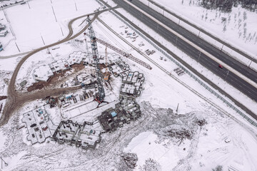 construction of new building in suburb residential area at winter time. aerial view.