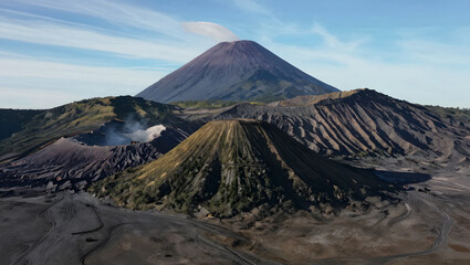 A view from below a smoking volcanic mountain.
