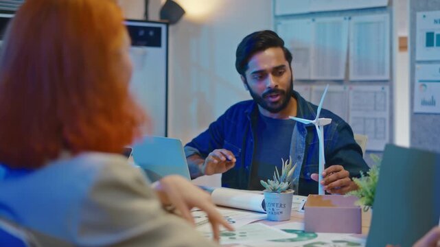 group of multiethnic businesspeople in team meeting,using tablet computer for Net zero,ESG topic presentation on monitor. Sustainable business practice,global warming,earth day,ESG team concept