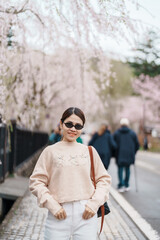 Fototapeta premium Woman tourist sightseeing Sakura Cherry Blossom in Spring. Happy traveler travel in Samurai village or Little Kyoto in Kakunodate town, Semboku District, Akita Prefecture, Japan. Landmark and Vacation