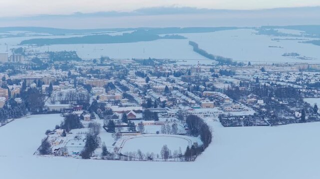 Drone panorama of Svitavy during winter, city blanketed in snow.
Wide aerial landscape showing houses and seasonal calm.