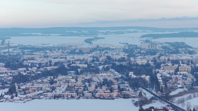 Snow-covered Svitavy cityscape in winter, panoramic drone shot.
Aerial view of houses and streets in frozen landscape.