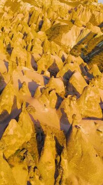 Vertical video. Goreme, Nevsehir, Turkey. Sunset aerial view of Devrent Imagination Valley with vibrant colored rock formations and surreal landscapes in Cappadocia.. Aerial View. Rich colors