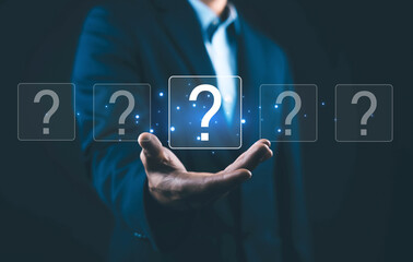 Naklejka premium Business decision concept with businessman holding glowing question mark icons, symbolizing choice, problem solving, strategy, uncertainty, analysis, innovation, and decision making in modern business