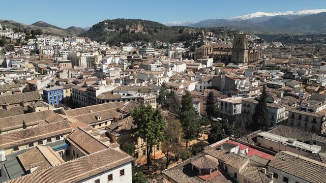 Descending drone video showcases central Granada, a historic town nestled in Andalusia province, Spain.