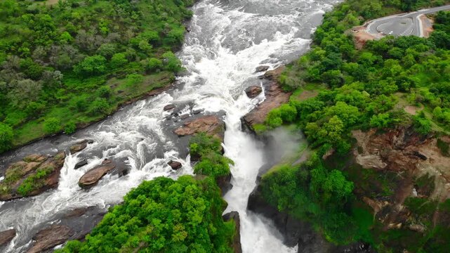 Aerial View Of Rocky Cascade, Overhead Perspective Of Waterfall With Surrounding Greenery And Mist. Media