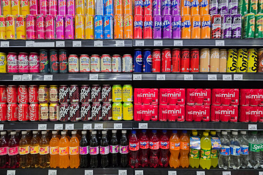 Penang, Malaysia: Nov 6, 2025: Neatly organized rows of canned beverages including Coca-Cola, Fanta, Sprite, and various flavored sodas at a grocery store in Bayan Lepas.