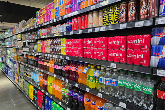 Penang, Malaysia: Nov 6, 2025: Neatly organized rows of canned beverages including Coca-Cola, Fanta, Sprite, and various flavored sodas at a grocery store in Bayan Lepas.