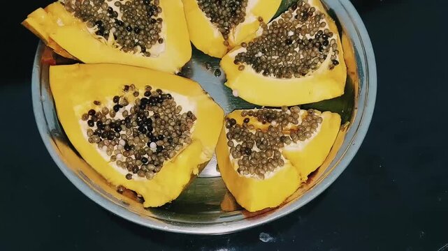 close up of Carica papaya slices with seeds and vibrant flesh