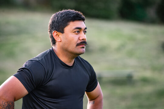 Samoan man looking serious with hands on his waist