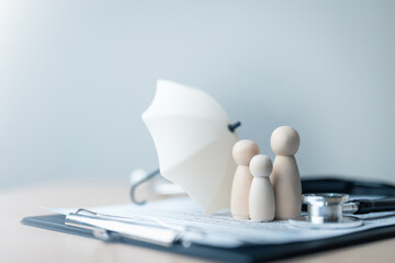 Health insurance concept with family figures protected by umbrella and medical tools. Represents...