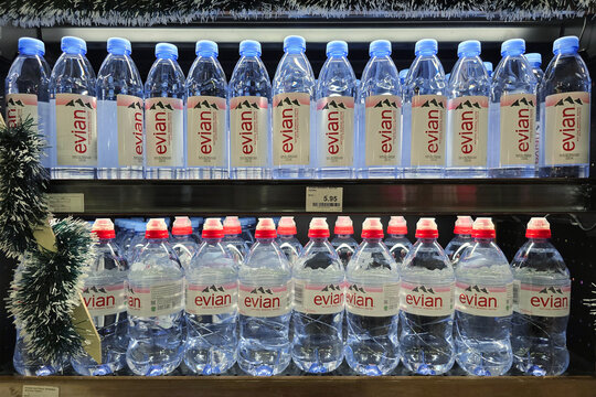 Penang, Malaysia &ndash; November 6, 2025: Rows of Evian natural mineral water bottles displayed on refrigerated supermarket shelf with visible price tag.