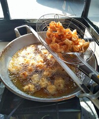 Deep Frying Golden Crispy Dumplings in Hot Oil. Traditional Asian Street Food Preparation.