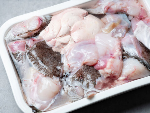 Raw monkfish cut into pieces on a plate