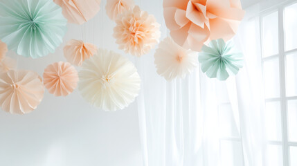 Handmade paper decorations hanging from ceiling in pastel colors with soft natural light through window curtains creating delicate atmosphere
