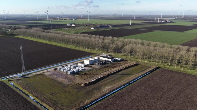 Aerial drone video of battery storage systems at a wind park in Zeewolde, , showcasing grid optimization, net congestion solutions, and the energy transition.