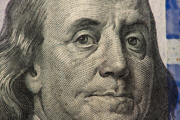 Macro close-up of Benjamin Franklin on a US 100 dollar bill. Detailed hundred dollars money...