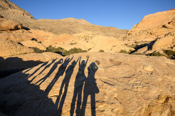 Long shadows of a group of women on the rocks. Calico Hills Trail. Red Rock Canyon National...