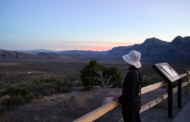 Woman looking at views at sunset. High Point Overlook. Red Rock Canyon. Nevada. USA.