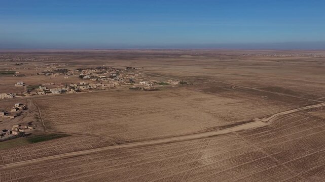 Drone shot capturing the vast, arid desert environment surrounding Al-Shaddadi in Al-Hasakah province, Northeast Syria. 