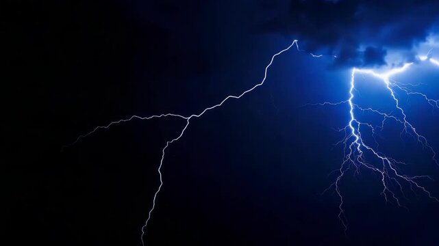 Dramatic blue lightning strike illuminating dark stormy night sky with electric discharge