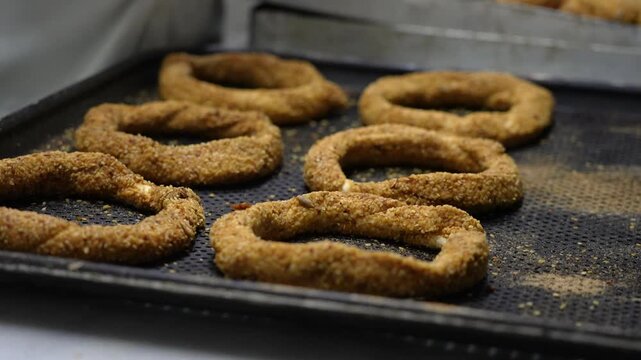 Baker preparing fresh simit bagels in Istanbul, Turkey
