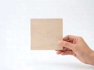 Obraz premium Hand Holding Blank Square Wooden Board on White Background Template