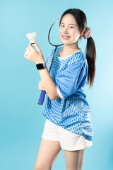 Obraz premium Portrait Badminton player woman happy smiling. Fun action sport play. Asian woman teen girl with badminton racket and shuttlecock. Badminton Player Athlete action in studio