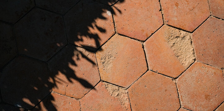 Hexagon outdoor paving stone tiles, paving cobble stone in red terracotta stone color with shadow