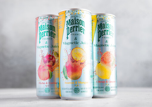 LONDON,UK - AUGUST 09, 2025: Aluminium cans of Perrier carbonated mineral water with various fruit flavors on table background.