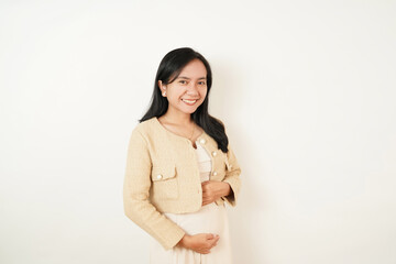 Obraz premium Portrait of Indonesian Woman with Pregnant Pose hand on stomatch and Subtle Smile Isolated on White Background