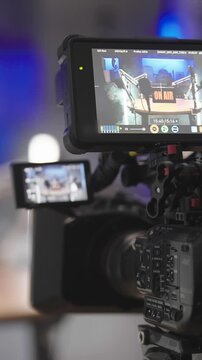 Professional camera viderecording podcast set surrounded with white led tubes