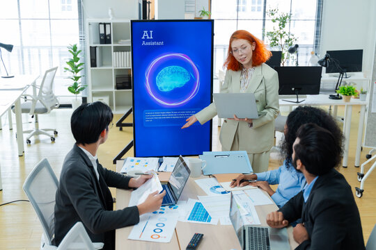 Diverse creative team use Ai Assistant (artificial intelligence assistant) on AI-assisted display for Marketing Data Analyst meeting at office.Coding team,develop Ai Assistant,business brainstorming