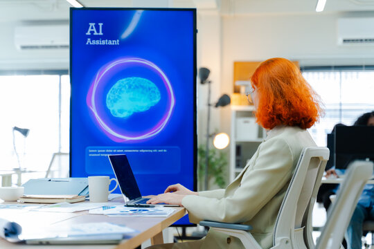 Diverse creative team use Ai Assistant (artificial intelligence assistant) on AI-assisted display for Marketing Data Analyst meeting at office.Coding team,develop Ai Assistant,business brainstorming
