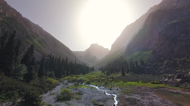 FPV flight above the frozen Ala Kul glacier lake, dramatic highland hike terrain and epic mountain views.