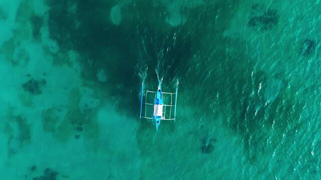 Backward drone motion emphasizes scale stillness, isolation in island seascape